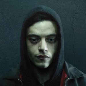 Elliot Alderson in a dark hoodie with a black background